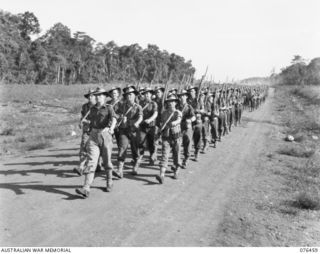 LAE, NEW GUINEA. 1944-10-07. A MARCH PAST THE 2/8TH COMMANDO SQUADRON. IDENTIFIED PERSONNEL ARE:- CORPORAL M.J. CHALMERS (1); NX125328 LIEUTENANT H.F. HARDMAN (2); CORPORAL I. VINCENT (3); CORPORAL ..