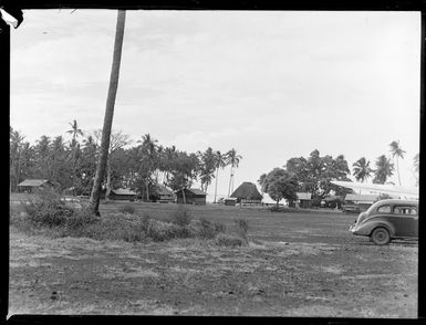 View of buildings amongst palm trees at the end of Faleolo Airport, Western Samoa