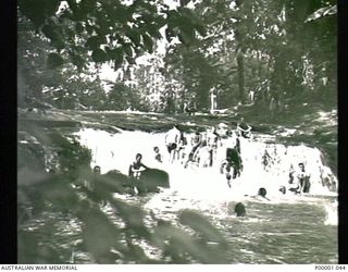 THE SOLOMON ISLANDS, 1945-01-12. AIF PERSONNEL RELAXING IN RIVER RAPIDS. (RNZAF OFFICIAL PHOTOGRAPH.)