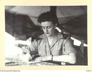 WUNUNG PLANTATION, JACQUINOT BAY, NEW BRITAIN. 1945-03-02. VFX138593 SISTER M. O'LOUGHLIN, 105TH CASUALTY CLEARING STATION WRITING A LETTER HOME DURING HER OFF DUTY PERIOD