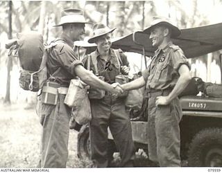 ALEXISHAFEN NORTH, NEW GUINEA, 1944-08-30. VX68698 CRAFTSMAN S.T. CORRIE (1) SAYING FAREWELL TO VX64378 STAFF SERGEANT C. VAUDE (2) AND VX63953 DRIVER W. NOY (3) AS HE LEAVES HEADQUARTERS, 2/15TH ..