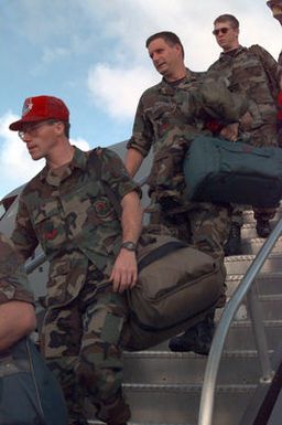 Members of the 200th and 201st Red Horse Air National Guard, Rickenbacker Air National Guard Base, Columbus, Ohio, disembark at Andersen Air Force Base, Guam, to help in the housing relief effort after Super Typhoon Paka