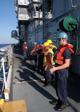 U.S. Navy Deck Seamen onboard the Tarawa Class Amphibious Assault Ship USS SAIPAN (LHA 2) prepare to conduct an underway replenishment operation in the Mediterranean Sea on Sept. 1, 2006. SAIPAN is currently conducting maritime security operations in the area. (Navy photo By Mass Communication SPECIALIST Third Class Gary L. Johnson III) (Released)