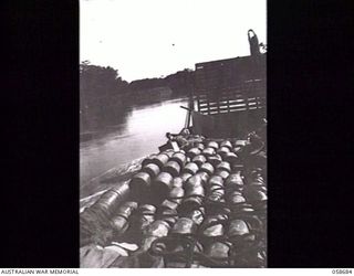 TERAPO, NEW GUINEA. 1943-09-16. AN AUSTRALIAN LANDING CRAFT MECHANISED, LOADED WITH 15 TONS OF RATIONS, MOVING UP THE RIVER. NATIVE AT THE BOW IS WATCHING OUT FOR SNAGS