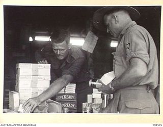 CAPE WOM, WEWAK, NEW GUINEA, 1945-07-31. CANTEEN GOODS BEING ISSUED TO VARIOUS 6 DIVISION UNITS AT THE CANTEEN ISSUING POINT AT HEADQUARTERS 6 DIVISION, OPERATED BY THE AUSTRALIAN ARMY CANTEENS ..