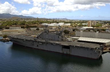 Port quarter view of the Tarawa Class Amphibious Assault Ship USS TARAWA (LHA-1) moored pier side at the Navy Supply Depot, Pearl Harbor. She is here to participate in the exercise Rim of the Pacific (RIMPAC) 2004. RIMPAC is the largest international maritime exercise in the waters around the Hawaiian Islands. This years exercise includes seven participating nations: Australia, Canada, Chile, Japan, South Korea, the United Kingdom and the United States. RIMPAC enhances the tactical proficiency of participating units in a wide array of combined operations at sea, while enhancing stability in the Pacific Rim region