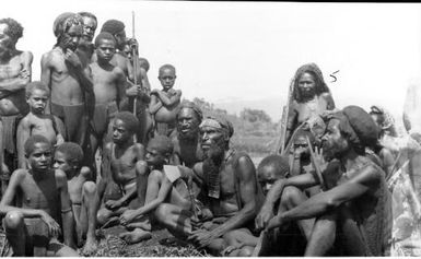 Kudi, chief man of Mogei region, Mount Hagen, with a group of people, 1934 [G. Heydon]