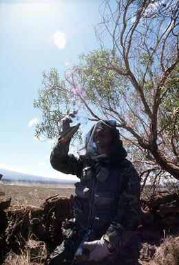 Forward air control team member 1ST LT. Doug Bennett uses a signal mirror to signal an 0-2 aircraft during search and rescue training conducted as part of exercise Cope Elite '81. 1ST LT. Bennett is from the 22nd Tactical Air Support Squadron