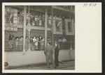 Lining the rails of the SS Shawnee, in Los Angeles Harbor, to bid farewell to friends, are a group of