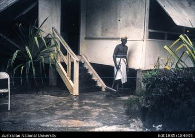 Papua New Guinean man outside building