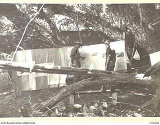 WEBER POINT, NEW GUINEA, 1944-02-14. NX112661 LIEUTENANT COLONEL P.W. CROSKY, (1), COMMANDING OFFICER 4TH INFANTRY BATTALION, WITH NX124560 LIEUTENANT T.F. WADE-FERREL, THE LIAISON OFFICER, 8TH ..