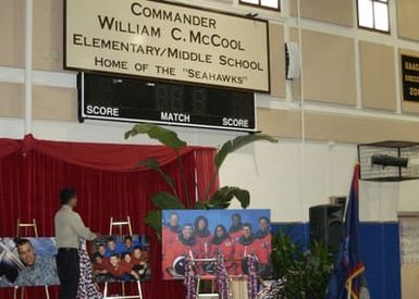 Sean McCool, son of the late Columbia space shuttle Astronaut Commander (CDR) William McCool, helps unveil a new school sign during the renaming ceremony of the Department of Defense Education Agencys (DODEA) Guam South Elementary and Middle School, in his fathers honor