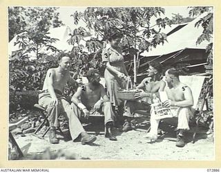 PORT MORESBY, NEW GUINEA. 1944-05-05. PATIENTS WHO ARE RESTING IN THE SUN RECEIVE THEIR WEEKLY TOBACCO ISSUE FROM B2/301 SUPERINTENDENT MISS S. GRAHAM (3), A MEMBER OF THE AUSTRALIAN RED CROSS ..