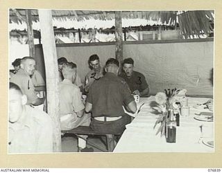 LAE, NEW GUINEA. 1944-11-11. LUNCHTIME IN THE SERGEANT'S MESS AT THE 112TH CONVALESCENT DEPOT. IDENTIFIED PERSONNEL ARE: SERGEANT G. CROCKETT (1), SERGEANT A.C. THOMPSON (2), WARRANT OFFICER II, J. ..