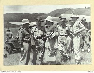 WAU, NEW GUINEA. 1944-04-24. THE HONOURABLE E.J. WARD, MINISTER FOR EXTERNAL TERRITORIES IN THE AUSTRALIAN GOVERNMENT (1) WITH MEMBERS OF HIS OFFICIAL PARTY ARRIVING AT WAU AIRFIELD DURING A TOUR ..