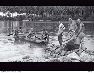 MILILAT, NEW GUINEA. 1944-07-14. PERSONNEL OF THE 10TH AIR LIAISON UNIT (RADIO) 5TH AIR FORCE, UNITED STATES ARMY, RELAXING WITH THEIR NATIVE LAKATOI ON A SMALL RIVER NEAR THEIR CAMP