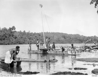 MALASIGE, NEW GUINEA, 1943-10-23. NATIVE OUTRIGGER SAILING CANOE ON THE LAGOON