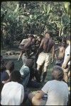 Local court case, child being pulled by men during a dispute over child's place between two groups