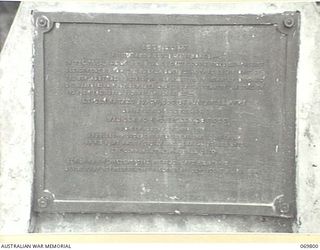 CAPE WOM, NEW GUINEA. 1945-09-13. PLAQUE ON A CONCRETE CAIRN ERECTED ON THE AIRSTRIP AT CAPE WOM TO COMMEMORATE THE SURRENDER OF THE 18TH JAPANESE ARMY BY LIEUTENANT GENERAL HATAZE ADACHI AND THE ..