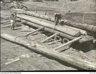 AITAPE, NORTH EAST NEW GUINEA. C. 1944-06. LOGS BEING UNLOADED AT A SAWMILL ESTABLISHED AND OPERATED BY NO. 7 MOBILE WORKS SQUADRON RAAF