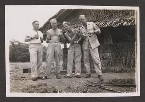 [Four Men in Front of Hut, #2]