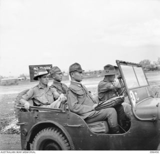 CAPE WOM, NEW GUINEA, 1945-09-13. WARRANT OFFICER 2 A. KLESTADT AND TWO JAPANESE STAFF OFFICERS ARRIVING IN AN AUSTRALIAN JEEP FOR THE SURRENDER CEREMONY HELD AT CAPE WOM AIRSTRIP. ..