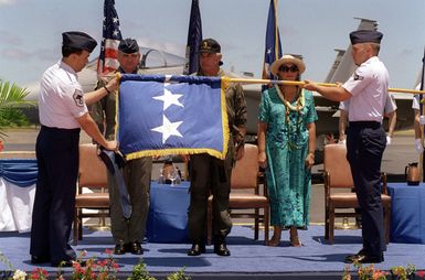 General (GEN) Ronald R. Fogelman, Air Force CHIEF of STAFF, GEN John G. Lorber, Commander of Pacific Air Forces, and Susan Lorber watch as GEN Lorber's four-star flag is rolled at GEN Lorber's retirement ceremony at Hickam AFB, Hawaii