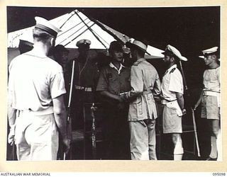 AT SEA, OFF BUIN, BOUGAINVILLE, 1945-08-20. LIEUTENANT H.J. JENKINS, ALLIED TRANSLATOR AND INTERPRETER SECTION, CARRYING OUT NEGOTIATIONS WITH A JAPANESE MESSENGER AFTER A REPLY TO A WIRELESS ..