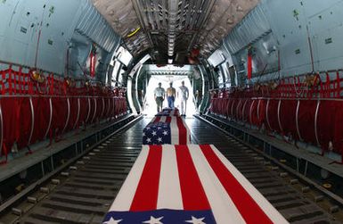Left to right: U.S. Army, STAFF SGT. Steven Robles, U.S. Marine Corps SGT. Anthony Riley, and U.S. Navy, Cryptologic Technician 3rd Class, Vincent Nguyen, stand at the tail end of a C-141 Starlifter cargo aircraft, with the remains of repatriated American warriors from the Korean War and World War II at Hickam Air Force Base, Hawaii, on Sept. 14, 2004.(U.S. Air Force PHOTO by Mysti Bicoy, CIV.) (RELEASED)