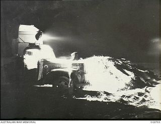 NADZAB, NEW GUINEA. C. 1944-02. FLOODLIGHT MOUNTED ON TRUCK TO ENABLE RECORD CREATING WORK BY NO. 62 MOBILE WORKS SQUADRON RAAF TO CONTINUE AT NIGHT AS WELL AS BY DAY