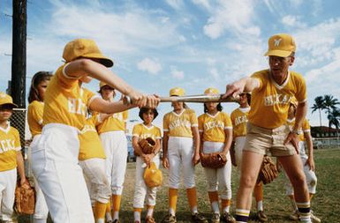 MASTER Sergeant (MSGT) Harold O. Overton provides batting instructions to a member of the girls softball team he coaches during off-duty hours. MSGT Overton is the chief of Defensive Command, Control, and Communications Countermeasures Branch, Electronic Security Pacific. January 84 AIRMAN Magazine