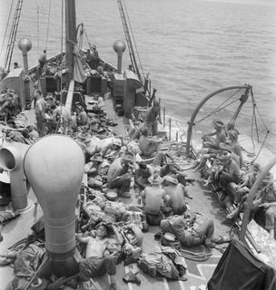 NEW BRITAIN. 1945-05-01. A MEMBER OF TROOPS OF A COMPANY, 37/52 INFANTRY BATTALION, RELAX ABOARD THE AK82, A VESSEL ON STRENGTH OF THE 16 WATERCRAFT COMPANY, ROYAL AUSTRALIAN ENGINEERS, IN MOVEMENT ..