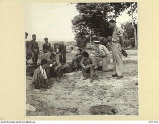 WASU, PAPUA, 1944-03-25. ENSIGN F. G. RYDER, UNITED STATES NAVAL RESERVE (USNR), ALLIED TRANSLATOR AND INTELLIGENCE SERVICE, DETACHMENT NO. 12, ATTACHED TO AUSTRALIAN FORCES OPERATING IN THE AREA ..