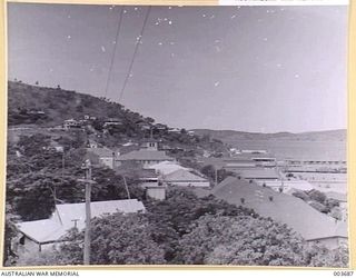 PORT MORESBY FROM AIR FORCE HEADQUARTERS. PART OF MILITARY RESERVE HILL AT LEFT. RAAF SURVEY FLIGHT. (NEGATIVE BY N. TRACY)