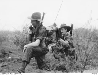 VX52907 Private (Pte) Edgar Norman Douglas Ward (left) and Pte G W Fisher (probably VX118680 Pte Geoffrey Wilson Fisher), members of 2/8 Infantry Battalion, operating a 108 wireless set to contact ..