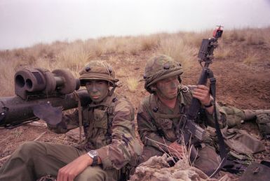SPEC. 4 Michael Olague and PVT. Gregory Kent of the 1ST Bn., 35th Inf., 25th Inf. Div., armed with the Dragon missile anti-tank weapon system and MILES (Multiple Integrated Laser Engagement System), watch for opposing forces on Puu Maile during their annual training exercises