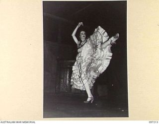 WEWAK POINT, NEW GUINEA. 1945-09-28. MISS A. LEE, A MEMBER OF THE DARYA COLLIN BALLET TROUPE, PERFORMING A SPANISH DANCE AT A THEATRE ERECTED AT HEADQUARTERS 6 DIVISION. THE DARYA COLLIN BALLET ..