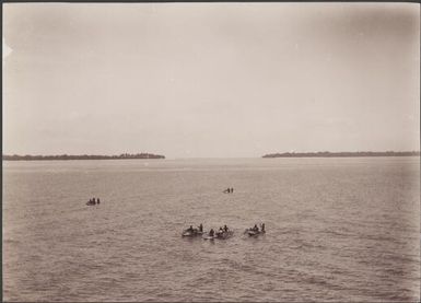 Lagoon between Nifiloli and Fenualua with Islanders in canoes in the foreground, Reef Islands, Swallow Group, Solomon Islands, 1906 / J.W. Beattie