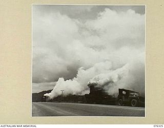 LAE, NEW GUINEA. 1944-09-27. PERSONNEL OF A UNITED STATES ARMY CHEMICAL WARFARE UNIT TESTING A PORTABLE SMOKE SCREEN TRUCK IN CO OPERATION WITH THE 43RD FIELD ORDNANCE DEPOT