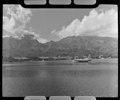 Papeete waterfront, Tahiti, showing Tasman Empire Airways Ltd (TEAL) flying boat in lagoon