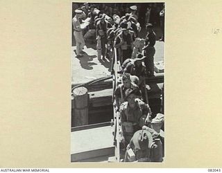 CAIRNS, QLD. 1944-10-30. TROOPS OF A COMPANY, 2/4 INFANTRY BATTALION, BOARDING THE TROOPSHIP USS MEXICO FOR EMBARKATION OF ELEMENTS OF 6 DIVISION FOR NEW GUINEA