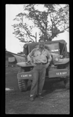 [Serviceman with military vehicle]