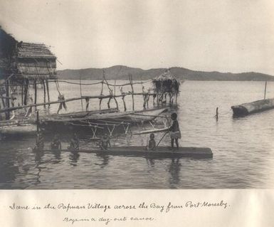 Boys in a dug-out canoe in the Papuan village across the Bay from Port Moresby, Papua New Guinea.