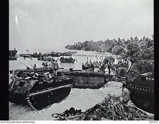 EMIRAU, ST MATTHIAS GROUP. 1944-03-20. SUPPLIES AND EQUIPMENT BEING BROUGHT ASHORE FROM LANDING CRAFT TO SUPPORT THE US MARINE LANDING FORCE. THE VEHICLES NEAREST THE CAMERA ARE LANDING VEHICLE ..