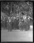 Group of people in ritual activity, wearing special attire