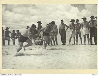 KELANOA, NEW GUINEA, 1944-02-20. THE SECOND HEAT OF THE 50 YARD DASH AT THE MOST FORWARD BEACH CARNIVAL IN NEW GUINEA, ORGANISED BY THE AUSTRALIAN ARMY AMENITIES SERVICE, 5TH DIVISION. IDENTIFIED ..