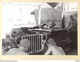 BOUGAINVILLE. 1945-08-30. PERSONNEL AT 2/4 ARMOURED REGIMENT WORKSHOP WORKING ON JEEPS WITH A SPRAYING PLANT. THESE FORWARD WORKSHOPS SERVICE MATILDA TANKS AND UNIT VEHICLES