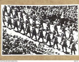 MELBOURNE, AUS. 1943-11-18. TROOPS OF 17TH AUSTRALIAN INFANTRY BRIGADE, MARCHING ALONG SWANSTON STREET UPON ITS RETURN TO THE MAINLAND AFTER A LONG TERM OF ACTIVE SERVICE IN NEW GUINEA