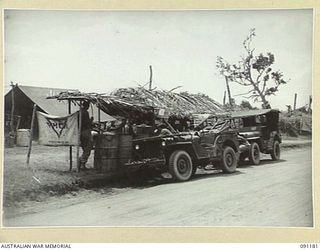 DAGUA AREA, NEW GUINEA. 1945-04-20. 2/1 INFANTRY BATTALION TROOPS AT THE YMCA COFFEE STALL AND NATIVE BUILT RECREATION HUT