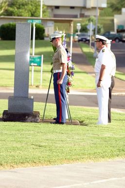 Two wreath bearers one US Marine Corps (USMC) Marine and one US Navy (USN) Sailor stage the memorial wreath at the Kaneohe Klipper Ceremony, on December 7, 2004, at Marine Corps Base Hawaii (MCBH) Kaneohe Bay